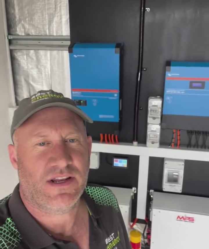 George from REST Energy beside the Victron off-grid system on the Tasman Peninsula