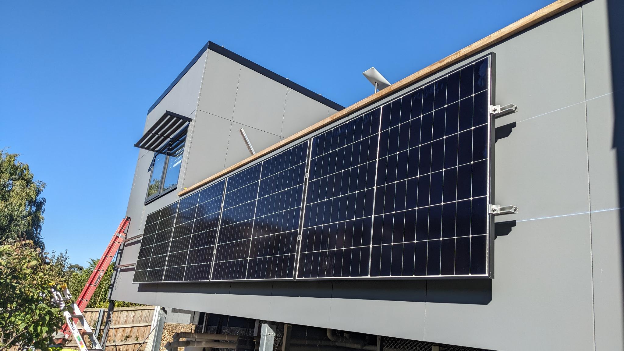 Vertical wall-mounted solar panels on a modern Tasmanian home